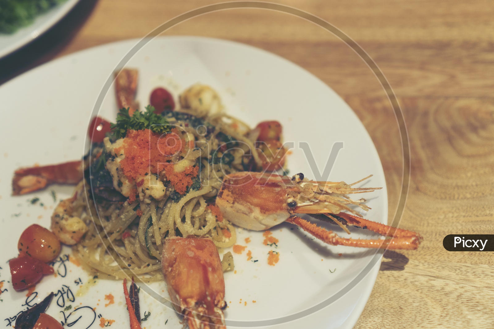 Spicy Spaghetti With Shrimp Served in a Restaurant Table