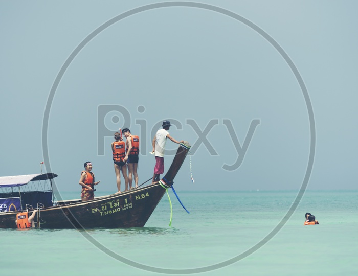 Tourists Enjoying Deep Sea Diving At Phuket Beach In Thailand