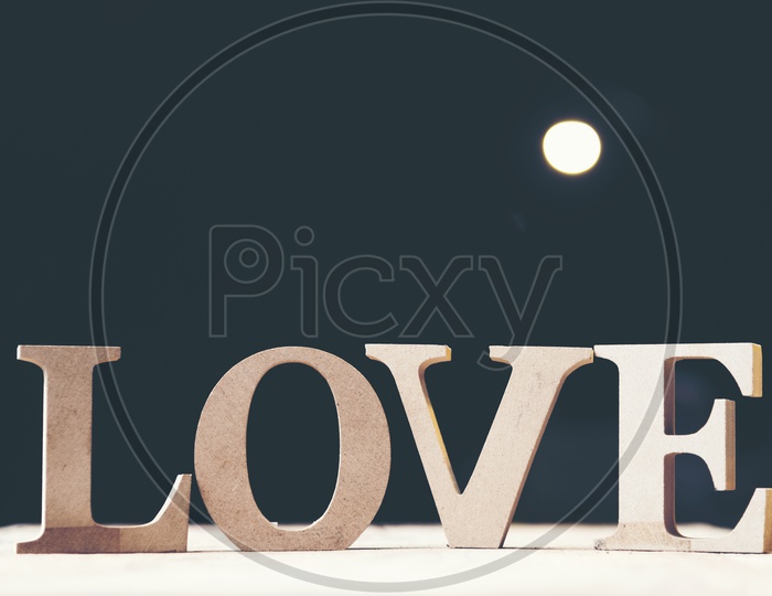 Wooden letters forming word LOVE with black background