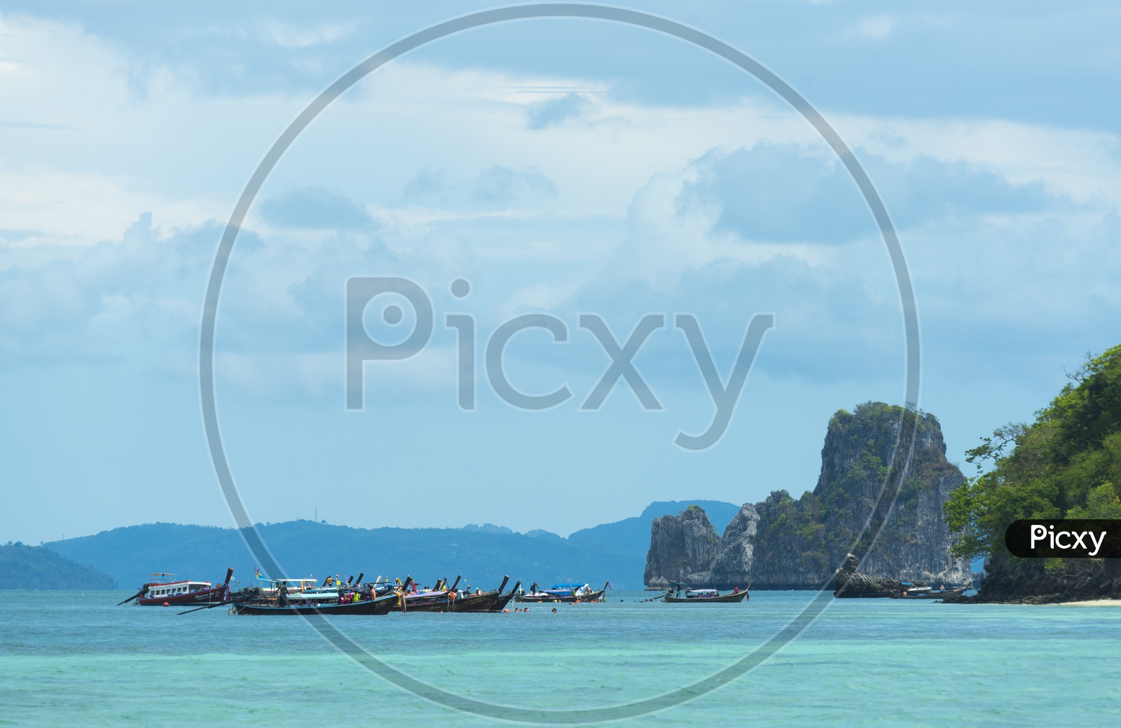 Tourist Boats Anchored At Krabi beach For Rock Formation Visits