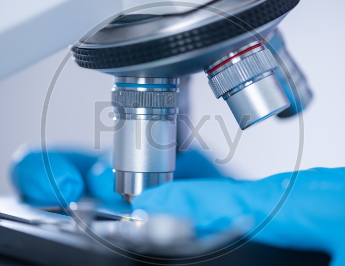 Researchers microscope in modern laboratories