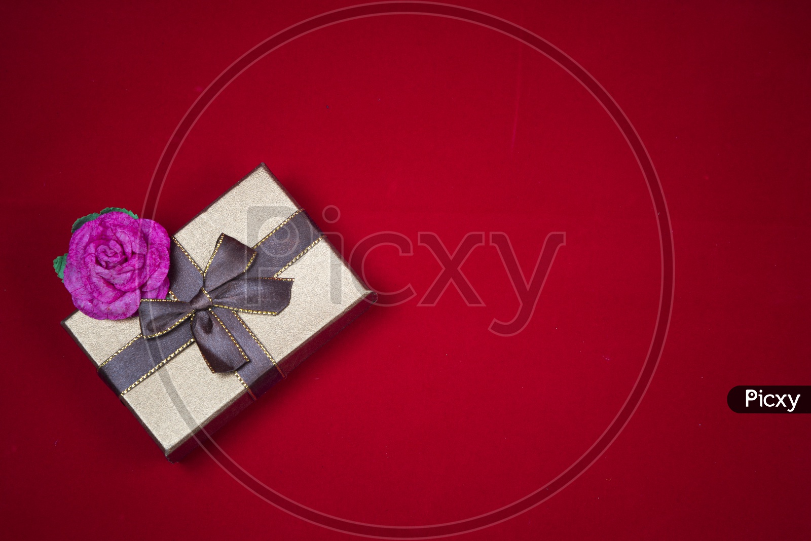 Gift box with a red rose on red background - abstract picture for Valentine day, vintage filter image