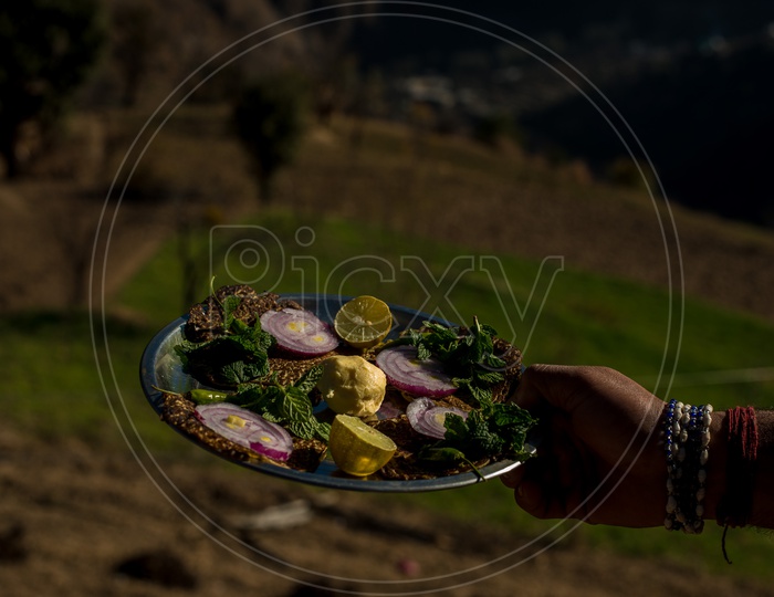 Mouth watering and authentic Himachali food over blured mountain background