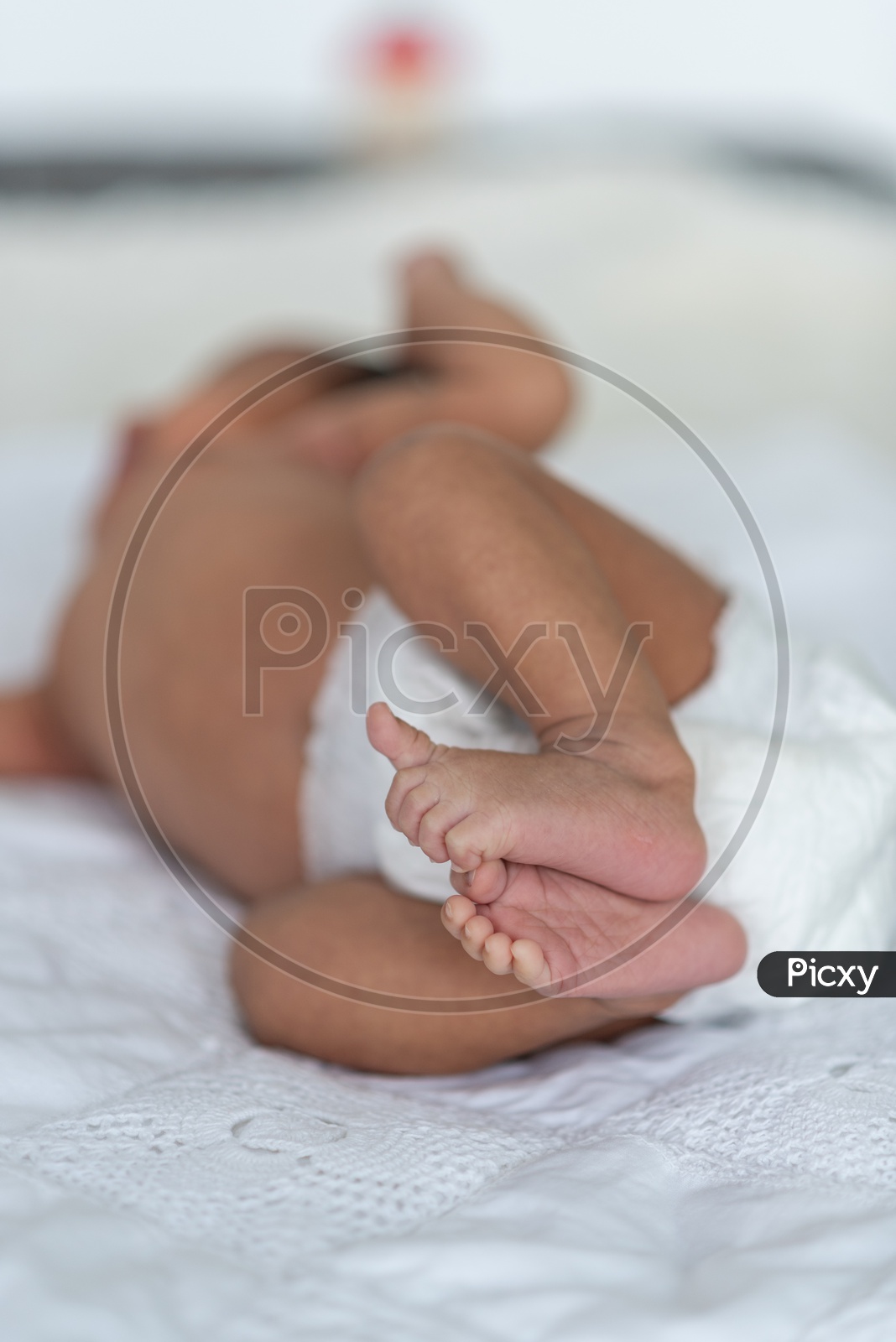 Newborn baby sleeping in bed