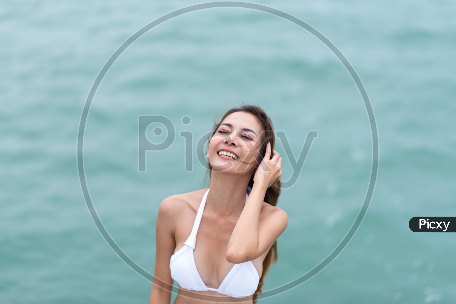 Young Asian girl in white bikini on Yacht