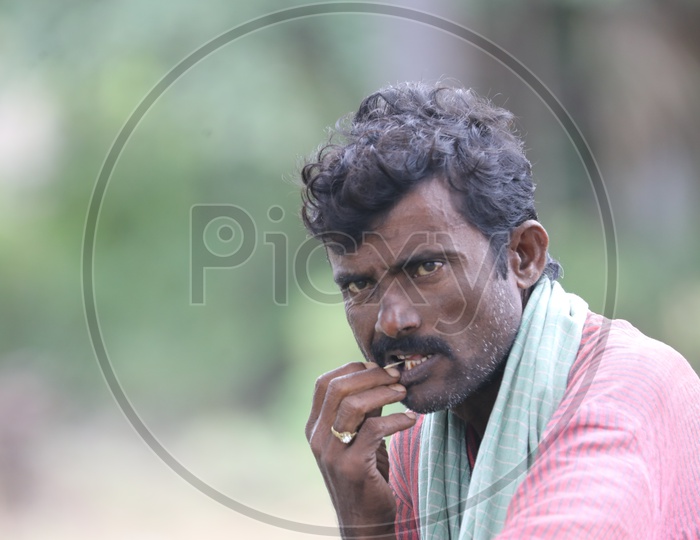 Indian Man using a Toothpick