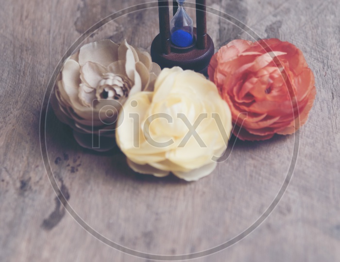 Top view image of rose flowers with hour glass - Valentine day concept