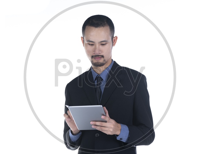 Handsome Asian Businessman with tablet computer isolated on a white background