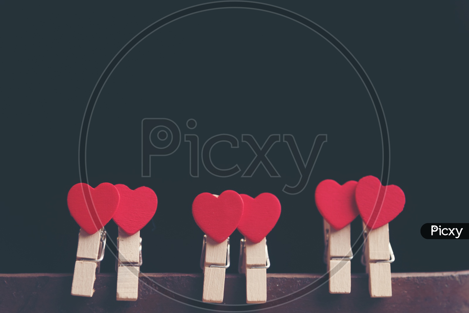 Love Concept For Valentines Day With red Hearts Couples  Hung On an isolated Black background