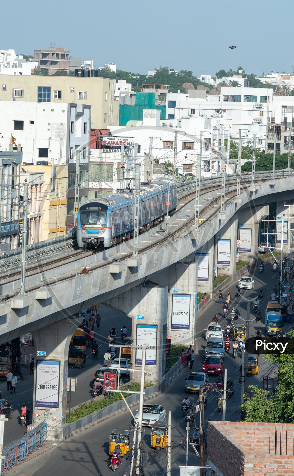 Metro train Running On Track Top View With Commuting Vehicles on roads