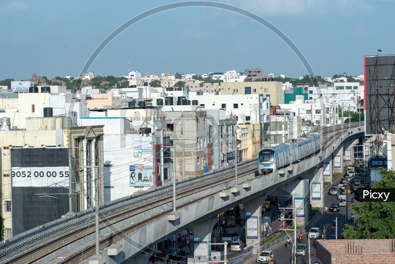 Hyderabad Metro Train running On Tracks  With High rise buildings View