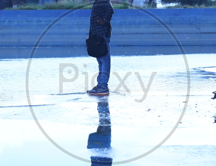 Indian Man standing on a wet surface