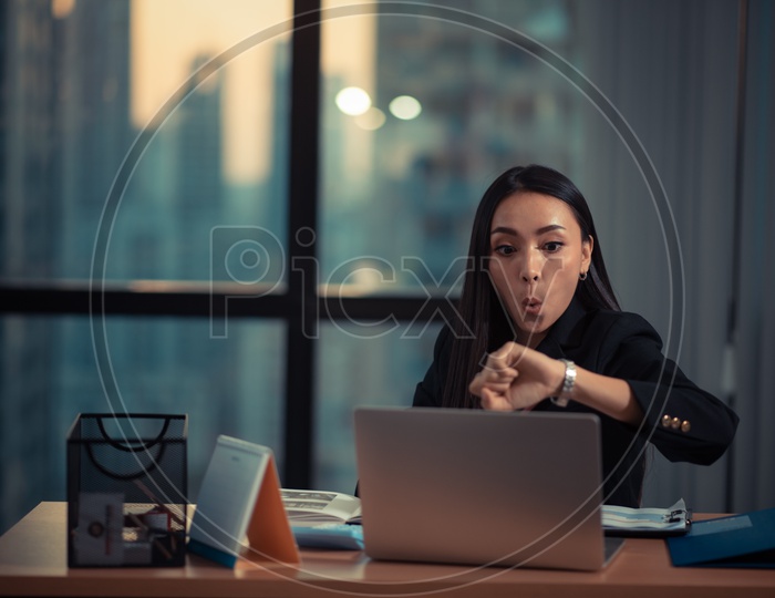 Young Asian Businesswoman working overtime at Office