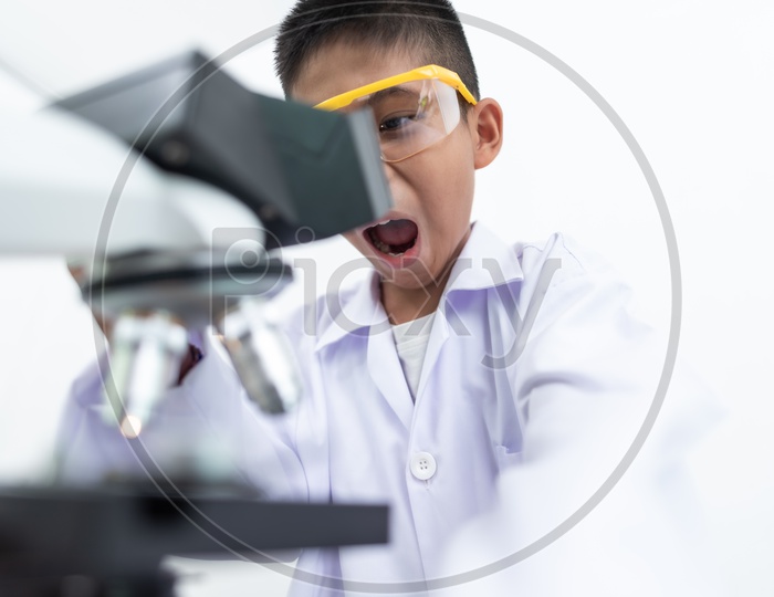 Closeup Shot of Child Scientist Looking at Microscope in Laboratory