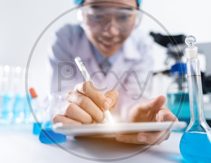 Asian Woman Scientist or Medical Student Working on her iPad at Laboratory