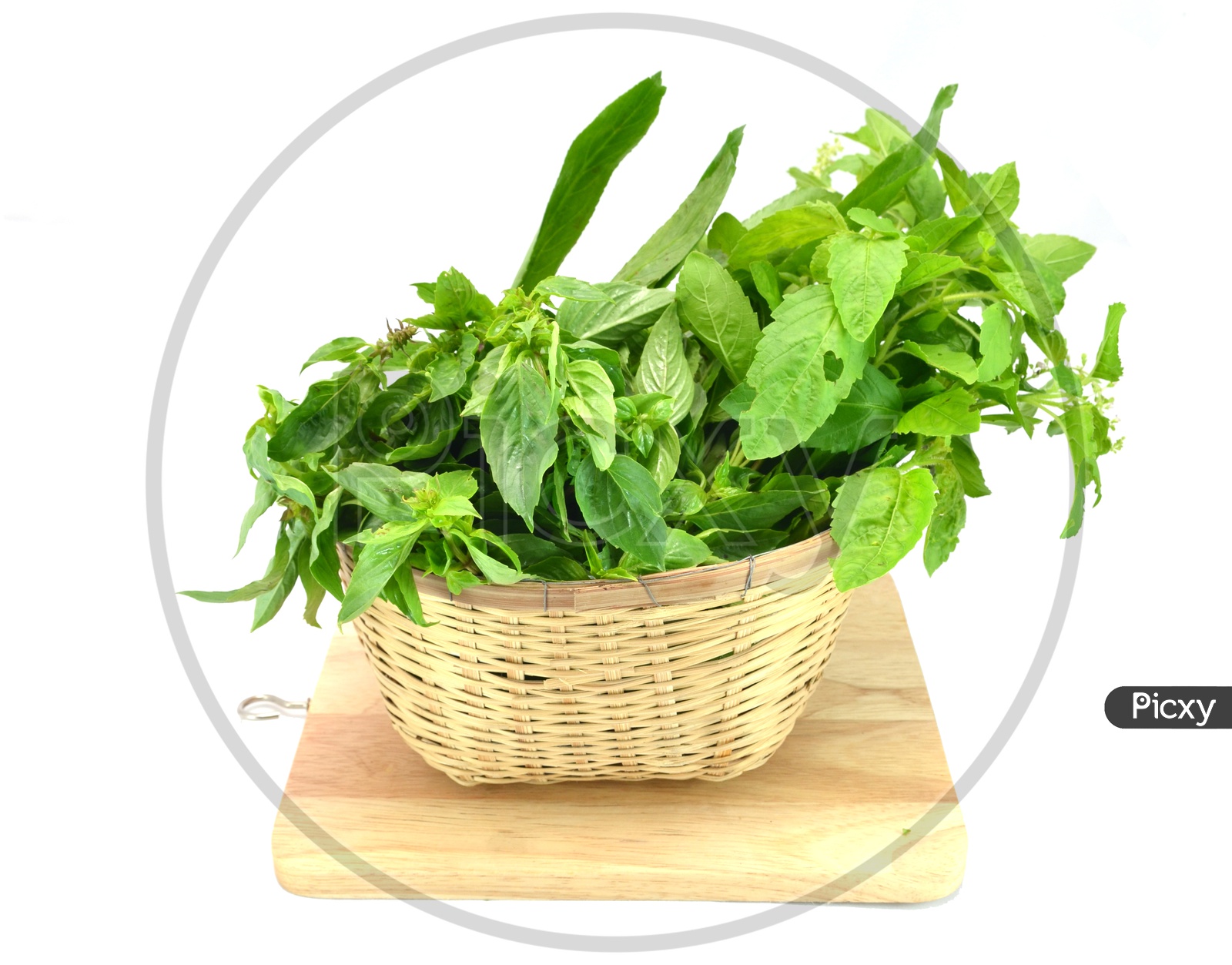Fresh Green Leafy Vegetables in an Wooden Weaved Basked On an isolated White Background