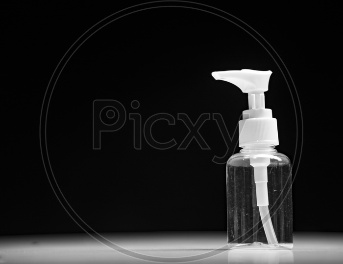 Empty cosmetic spray bottle container isolated on black background