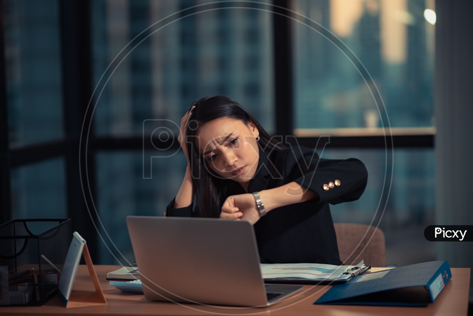 Young Asian Businesswoman working overtime in office, Employee checking Time