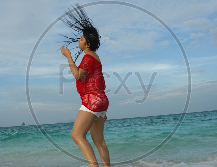Indian Girl doing a hairflip at the beach