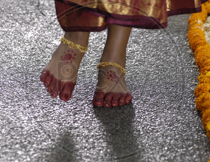 Indian Bride walking wearing Mehendi