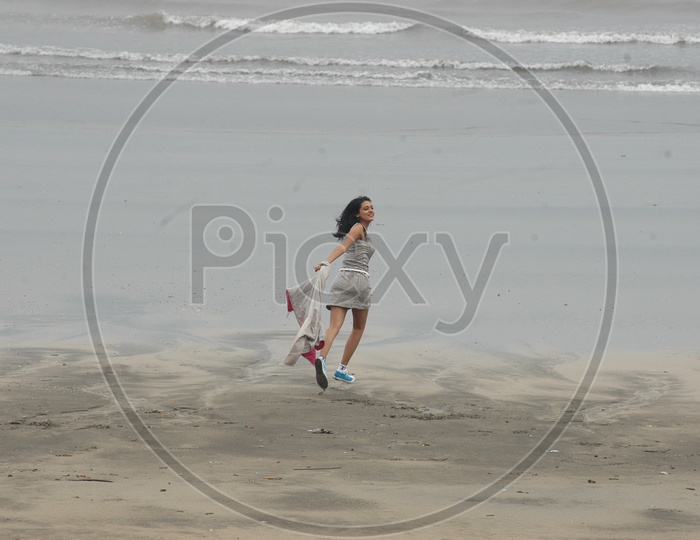 A Girl running taking her jacket off