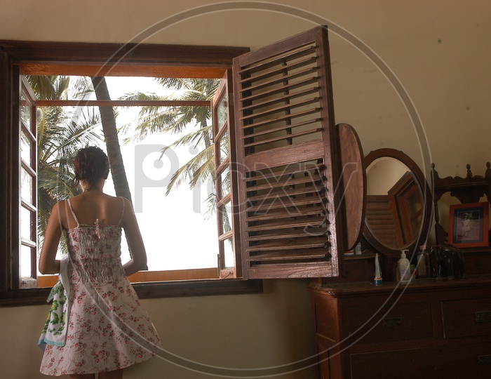 Indian Girl looking through a window