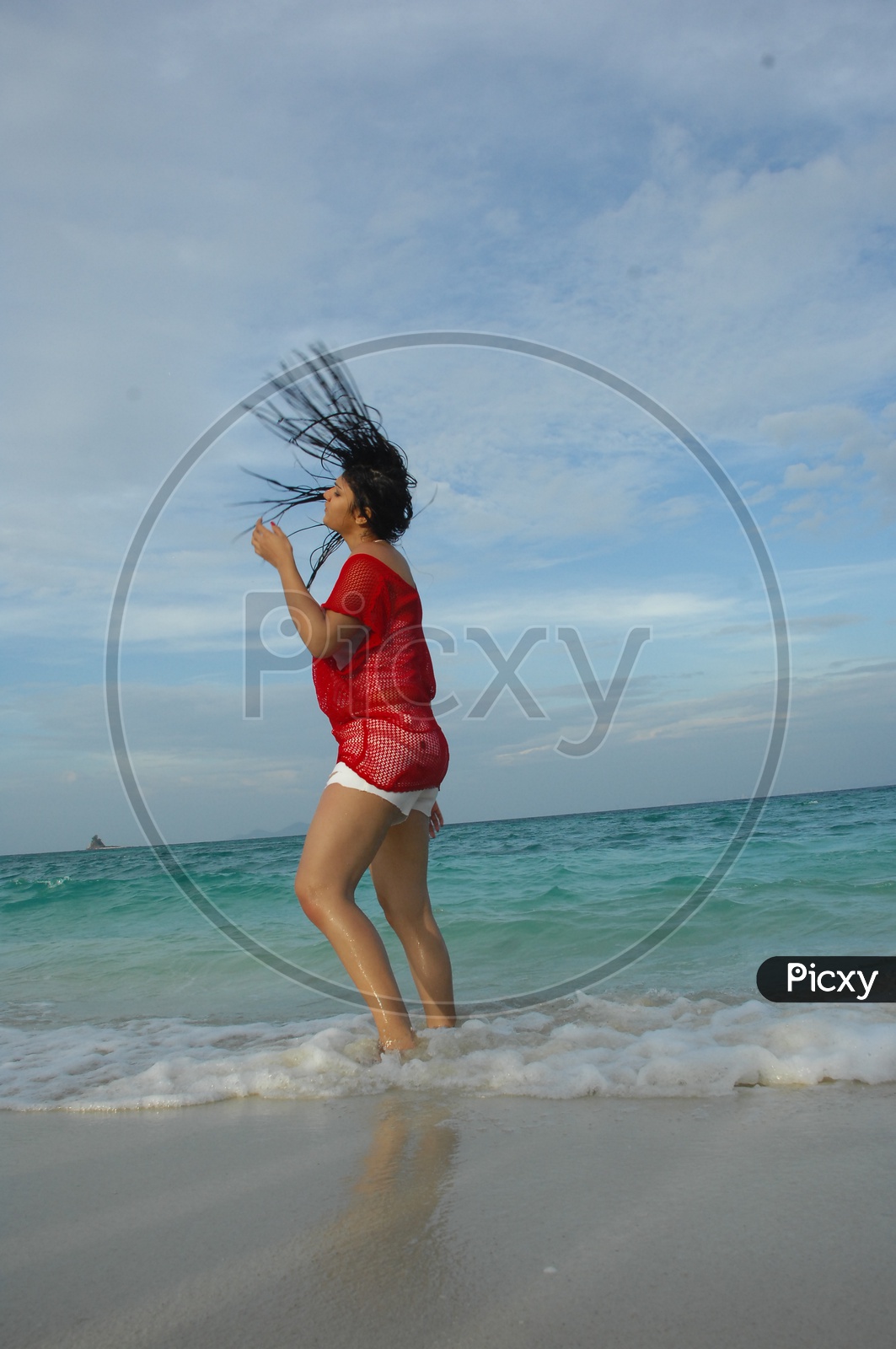 Indian Girl doing a hairflip at the beach