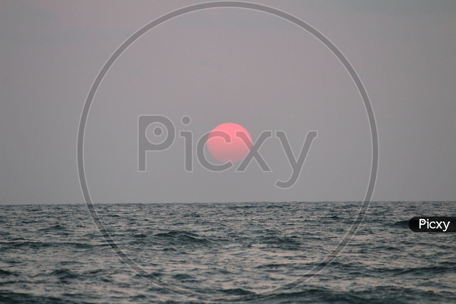 Sunset Over a Sea With Bright Round Sun
