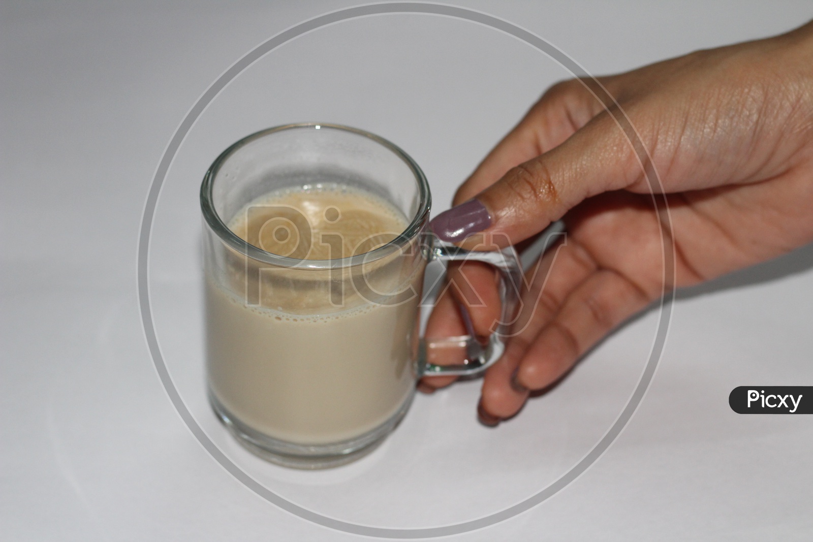Indian Woman Hand Holding Coffee Or Tea in a Glassware Cup On an isolated White Background