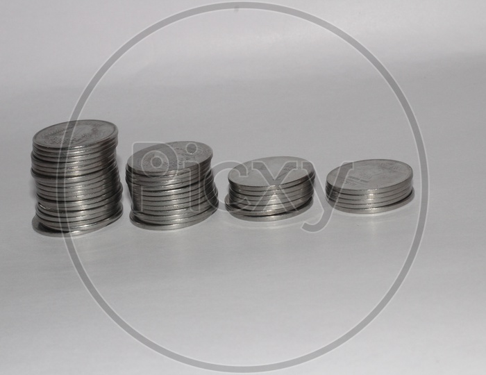 Indian Currency Coins Increasing Columns On an Isolated White Background