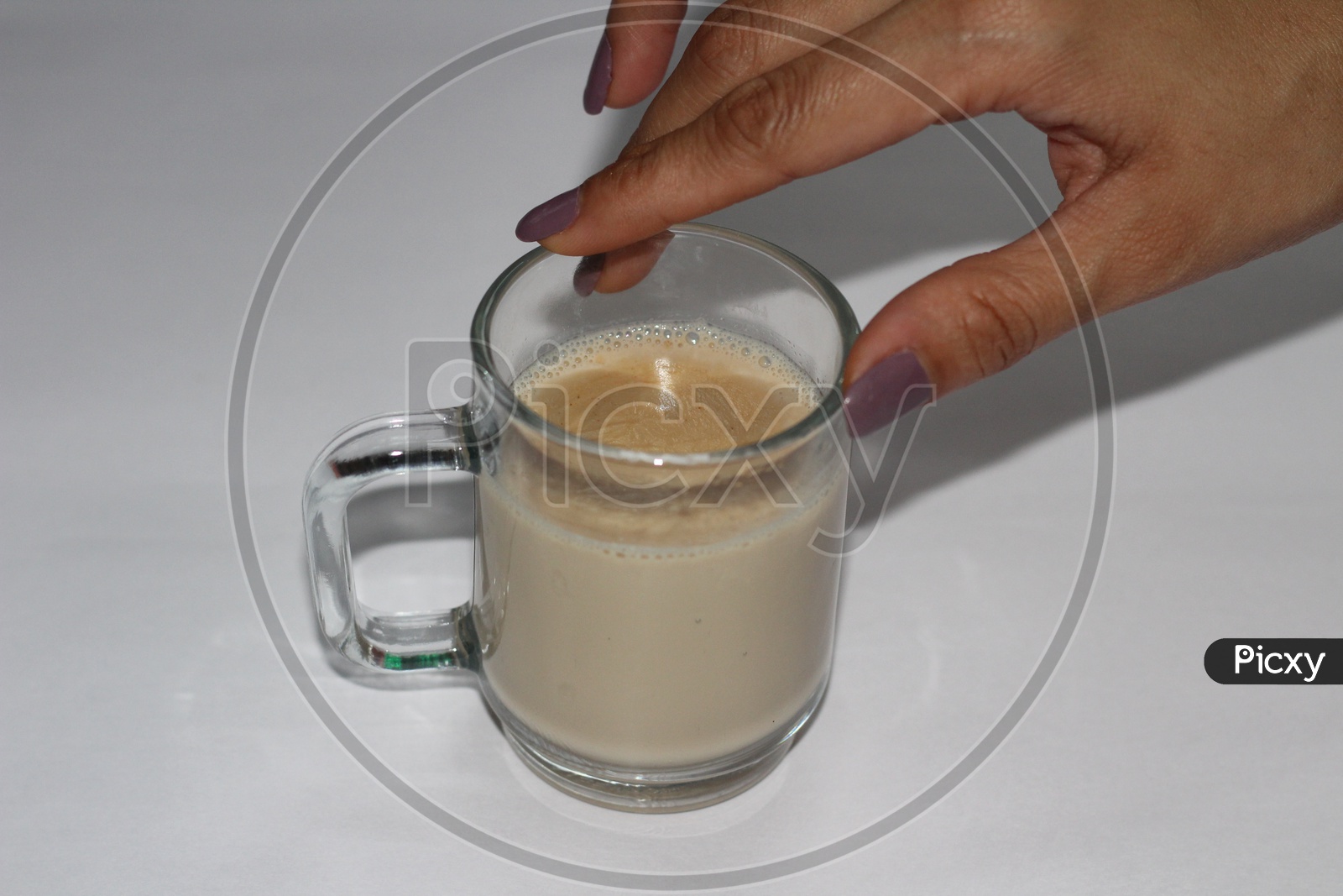 Indian Woman Hand Holding Coffee Or Tea in a Glassware Cup On an isolated White Background