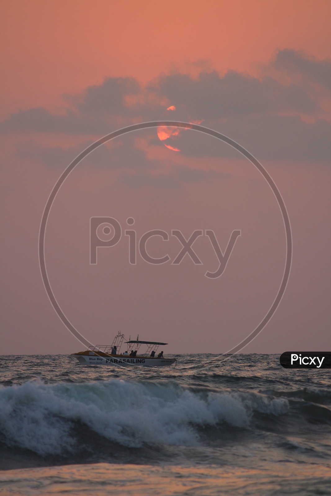 Tourists Boats in Sea With Sunset Sky In Background