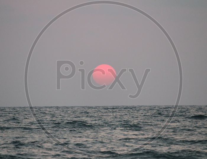 Sunset Over a Sea With Bright Round Sun