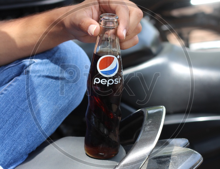 Pepsi Soft Drink or cool Drink Bottle holding in Hand