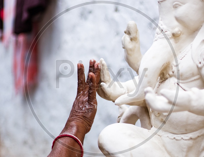 Ganesh Idol in Making , Artist Hand on Idol Closeup
