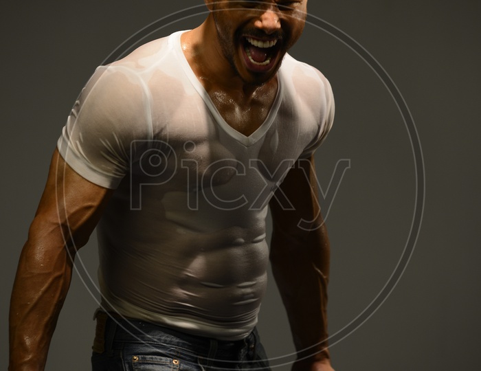 Indian Muscular Man shouting holding a pistol