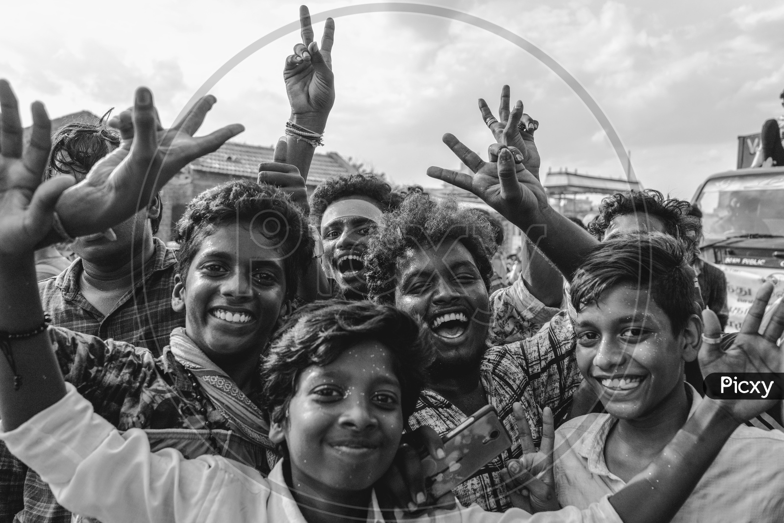 Monochrome picture of people posing for the camera at the lord ganesha nimarjan