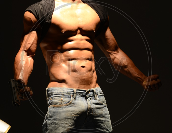Young Indian Man with Gun and  Six Pack