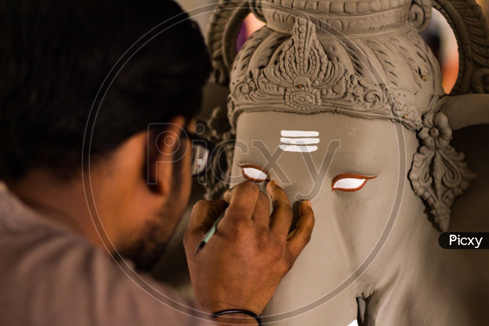 Artist Giving Final Finishings To Eco-Friendly Clay Ganesh idols