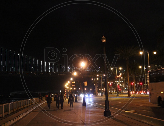 People walking along the footpath during night