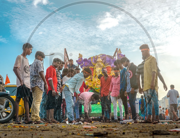 People offering coconut to lord ganesha during nimarjan.