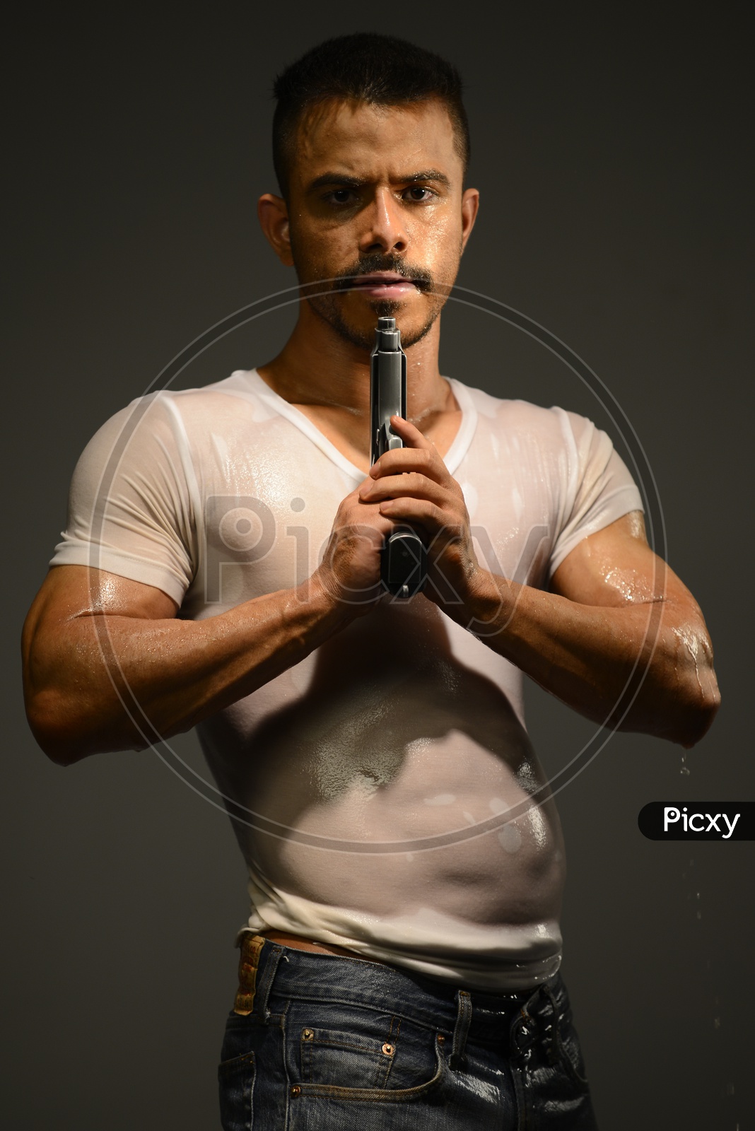 Drenched Indian Muscular Man pointing a gun to his face