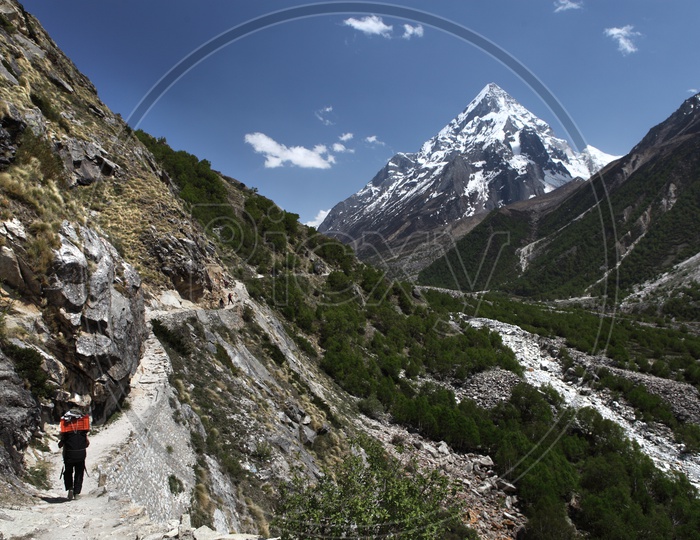 Beautiful Landscape  and porter carrying food on his back. Gangotri National Park area. Uttrakhand.