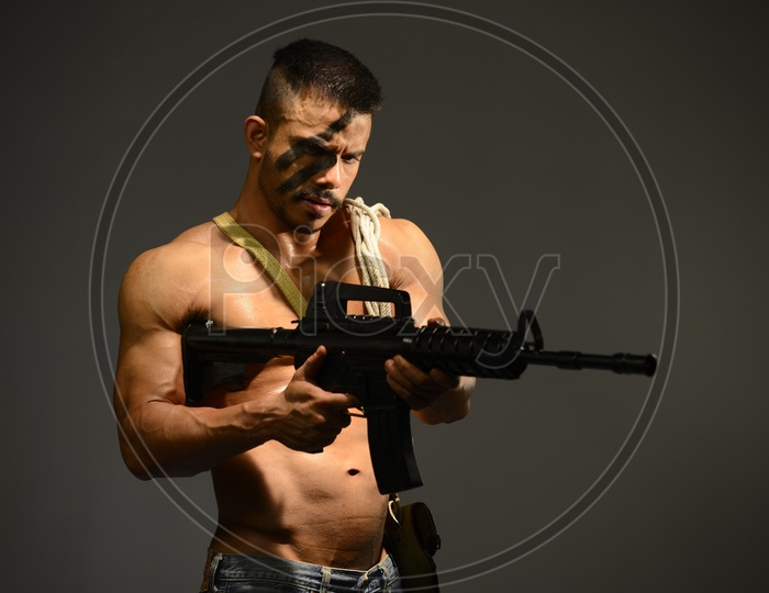 Indian Muscular Man holding an AK-47 Gun