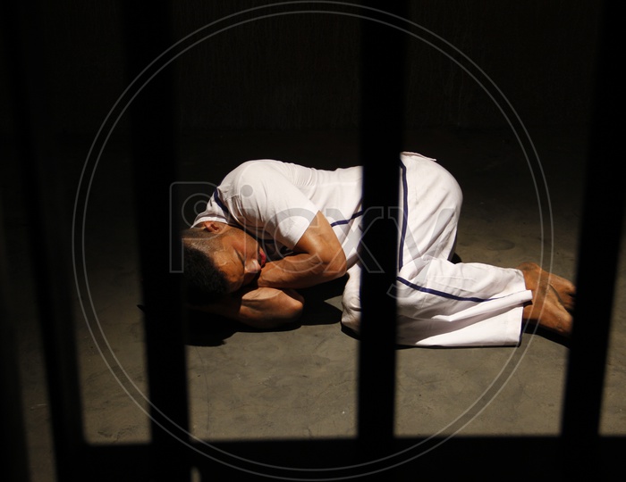 Image of Indian Male Prisoner in uniform Sleeping on Floor in a Jail