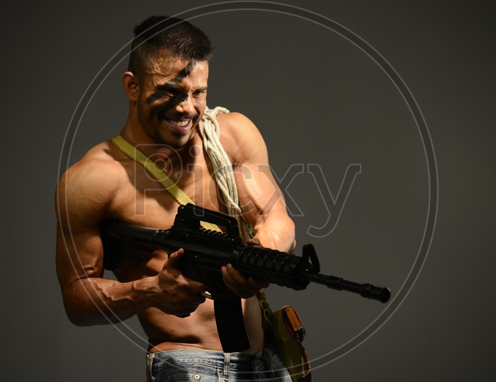 Indian Muscular Man during a screentest with Ak-47