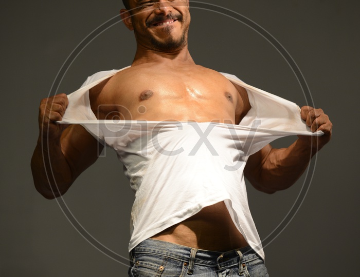 Indian Muscular Man tearing his vest