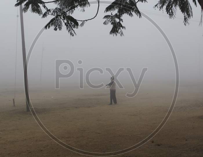 A Man In an Winter Fog on an Early Morning