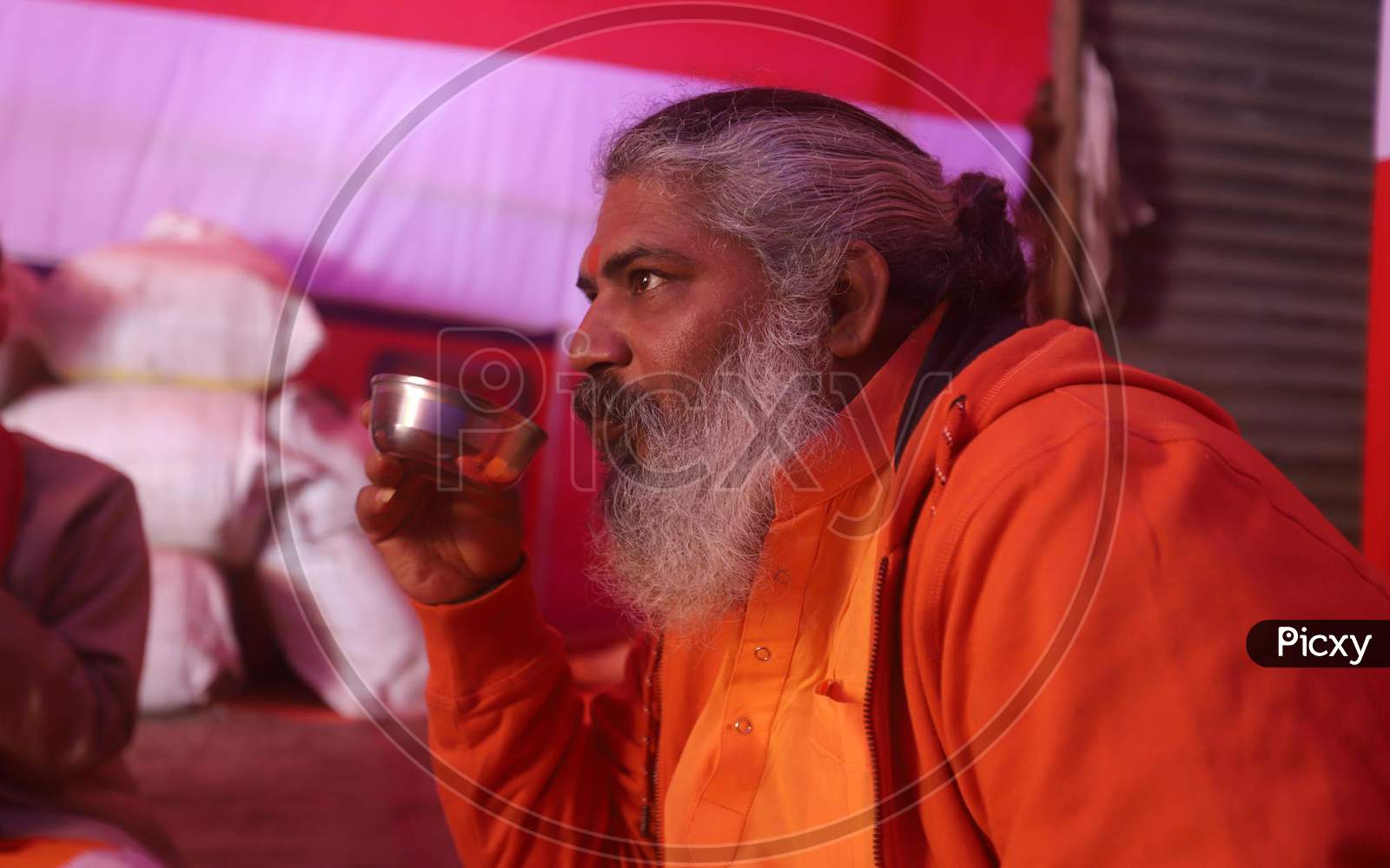 A Sadhu Or Holy Man Drinking Tea On A Cold And Fogy Weather In Side His Camp At Kumbh Mela In Allahabad, January 3.2019.
