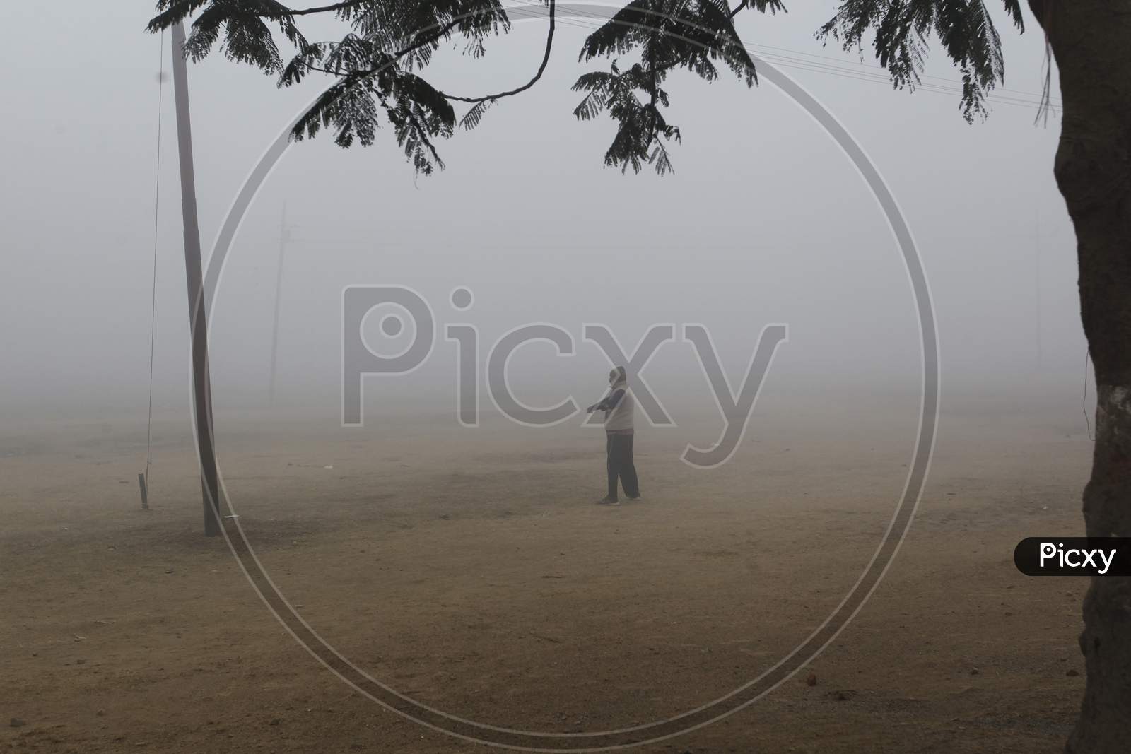 A Man In an Winter Fog on an Early Morning